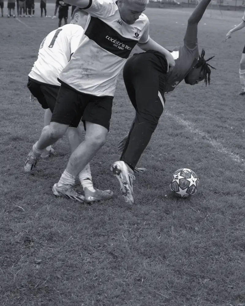 Two players challenge for the ball on the line at the 2024 Athlone's Finest tournament