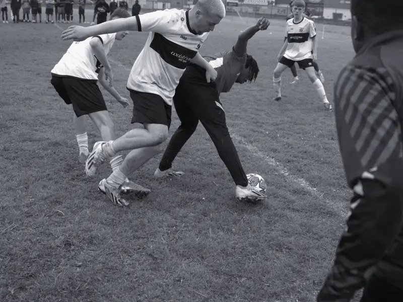 A tackle goes in as three players fight for possession at the 2024 tournament